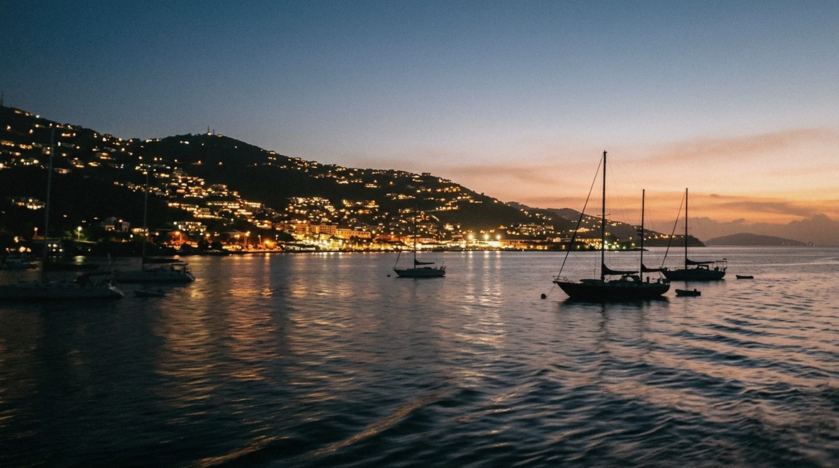 Charlotte Amalie harbor lights glowing at dusk during the best time for a sunset cruise in St. Thomas